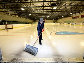 Facility attendant Aaron Dubetz clears the ice at the Henry Viney Arena in Calgary as arenas are starting to open up on Monday, June 29, 2020.
