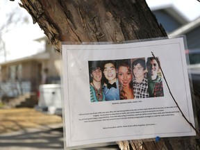 A photo of five young people killed in a 2014 attack hangs on a tree outside the Brentwood home a year later.