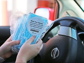 Masks are handed out at McDonald’s drive-through in Calgary on Wednesday, June 10, 2020.