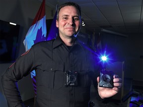 Calgary Police Service Staff Sgt. Travis Baker wears and holds the service's new Axon body camera on Tuesday July 3, 2018.