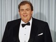 John Candy appears at the Academy Awards in April 1988.