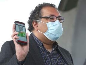 Mayor Naheed Nenshi displays the Calgary Transit's new My Fare mobile ticketing app in Calgary on Tuesday, June 30, 2020.  The app will help limit the amount of contact between customers, drivers, and high-touch surfaces.