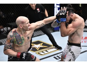 Josh Emmett punches Shane Burgos in their featherweight bout during UFC Fight Night at UFC APEX in Las Vegas on Saturday, June 20, 2020. Chris Unger/Zuffa LLC via USA TODAY Sports