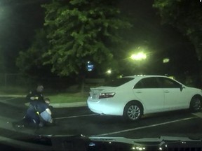 This undated handout photo obtained June 14, 2020, courtesy of the Atlanta Police Department, shows a video grab image from a video dash cam on June 13, 2020 of a struggle with Atlanta police officers and suspect Rayshard Brooks during an arrest in Atlanta.