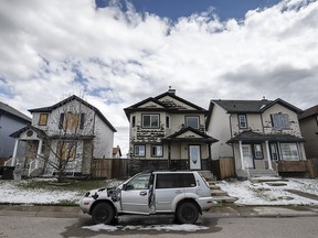 Residents in northeast Calgary survey the damage after a devastating hail storm hit the area on June 13, 2020.