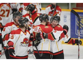 Kodie Curran hugs overtime hero Alex Dzielski as the University of Calgary Dinos celebrate a 2-1 overtime win over the University of Manitoba Bisons during CIS hockey playoff action in Calgary, Alta., on Sunday March 2, 2014. It was Game 3 of the Canada West semifinal series, launching them into the finals next weekend in Edmonton. Lyle Aspinall/Calgary Sun/QMI Agency