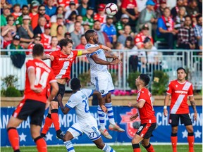 Aug 14, 2019; Calgary, Alberta, CAN; Montreal Impact forward Anthony Jackson-Hamel (11) and Cavalry FC defender Mason Trafford (5) jump for the ball during the first half during the Canadian Championship Semi-final soccer match at Spruce Meadows. Mandatory Credit: Sergei Belski-USA TODAY Sports for CPL ORG XMIT: USATSI-406479