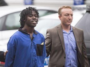 Lloyd Kollie, 19, was brought to the Calgary Police processing unit in Calgary on Wednesday, June 17, 2015.