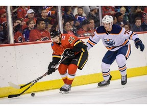 The Calgary Flames' Luke Philp and Edmonton Oilers' Dmitri Samorukov fight for the possession of the puck during the Battle of Alberta prospects game at Scotiabank Saddledome in Calgary on Sept. 10, 2019. Azin Ghaffari/Postmedia Calgary