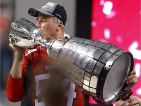 The Calgary Stampeders' head coach John Hufnagel kisses the cup as he celebrates winning the 102nd Canadian Football League Grey Cup championship. The Stamps beat the Hamilton Tiger-Cats 20-16 in Vancouver on Sunday, Nov. 30, 2104. Al Charest/Calgary Sun/QMI Agency