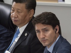 Canadian Prime Minister Justin Trudeau and Chinese President Xi Jinping listen to opening remarks on June 28, 2019 at a the G20 Summit in Osaka, Japan. (The Canadian Press)
