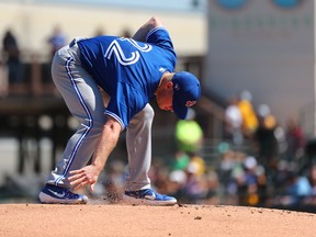 Toronto Blue Jays starting pitcher Chase Anderson (22) works on the mound before pitching against the Pittsburgh Pirates during the first inning at LECOM Park in March.