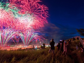 An extended fireworks display lights up the sky above Calgary and an empty Calgary Stampede grandstand and grounds on Friday, July 3, 2020.