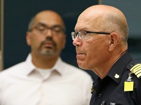 Dr. Raj Bhardwaj, a Calgary family physician and urgent care doctor, left, listens as Tom Sampson, Chief of the Calgary Emergency Management Agency answers Calgary City Council questions on possible mandatory mask rules on Monday, July 20, 2020.