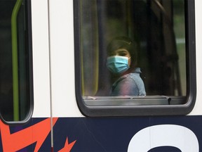 A CTrain rider wears a mask on Tuesday, July 21, 2020.