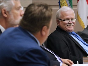 Calgary councillor Ray Jones looks down the desk towards embattled councillor Joe Magliocca during a council meeting in 2017.