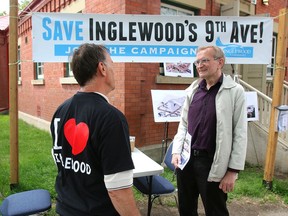 Phil Levson, President of the Inglewood Community Association, talks with volunteer Manfred Baum outside their headquarters on 9th Ave SW. Levson is campaigning to stop high-rise buildings from being developed in the community Friday, July 10, 2020.