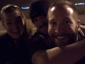 Aurora Police Department officers Erica Marrero, Jaron Jones and Kyle Dittrich reenact a chokehold near a memorial to Elijah McClain, in Aurora, Colorado, October 2019.