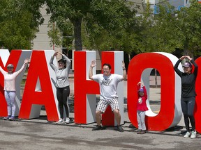 Members of the Cheng and Lee families pose for a fun photo at Stampede Park in Calgary on Sunday, July 12, 2020. The Calgary family visited the Stampede Grounds on what would have been the last Sunday of Stampede which was cancelled due to COVID-19 pandemic.