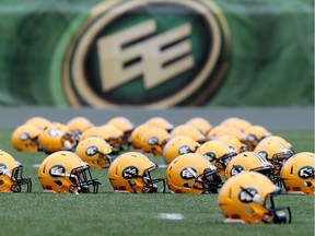 Helmets sit on the field during an Edmonton Eskimos team practice at Commonwealth Stadium in Edmonton on June 10, 2014.