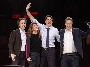 Canada's Prime Minister Justin Trudeau and his wife Sophie Gregoire-Trudeau are flanked by We Day co-founders Craig Kielburger, left, and Marc Kielburger, right. MATT DAY/OTTAWA SUN