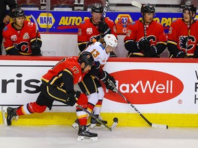 Milan Lucic and Johnny Gaudreau battle along the boards during a Calgary Flames intra-squad game at the Saddledome on Sunday July 19, 2020.