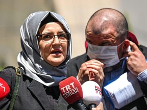 Hatice Cengiz, journalist Jamal Khashoggi's fiancee, speaks to the press as she leaves the Istanbul courthouse on Friday, July 3, 2020, after attending the trial of 20 Saudi suspects including two former aides to Crown Prince Mohammed bin Salman, accused of killing and dismembering her fiancee in 2018.