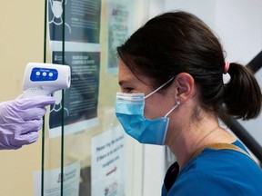 Jillian Golder, an employee of Oro Valley Hospital, has her temperature checked before receiving an antibody test for the coronavirus disease (COVID-19) at the University of Arizona in Tucson, Arizona, U.S., July 10, 2020.