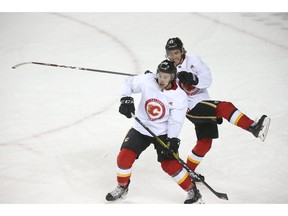 Flames Andrew Mangiapane (front) and Johnny Gaudreau collide during on ice drills during Calgary Flames training camp at the Saddledome in Calgary on Tuesday, July 14, 2020. Jim Wells/Postmedia