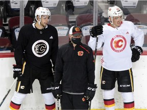 Calgary Flames Connor Mackey, left and Glenn Gawdin take part in the team's first practice since the COVID-19 shutdown at the Scotiabank Saddledome in Calgary on Monday, July 13, 2020.  Gavin Young/Postmedia