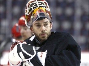 Flames goalie Cam Talbot pauses at the bench area during Calgary Flames practice in Calgary on  Tuesday, March 10, 2020. Jim Wells/Postmedia