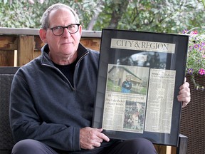 Max Lipsman holds old newspaper clippings in his backyard at his home in SW Calgary. Lipsman was across the lake at the BB-Riback Youth Camp when he oversaw the devastating tornado hit Pine Lake 20 years ago. Monday, July 13, 2020.