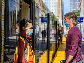 Transit riders at a downtown CTrain platform on Monday, June 22, 2020.