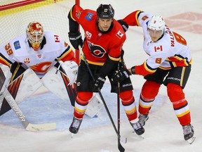 Milan Lucic flights for position between goalie Cam Talbot and Juuso Valimaki during a Calgary Flames intrasquad game at the Saddledome in Calgary on July 19, 2020. Al Charest/Postmedia