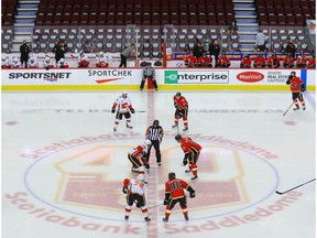 Members of the Calgary Flames are lined up for a faceoff during a intrasquad game at the Saddledome in Calgary on Sunday, July 19, 2020. Al Charest/Postmedia