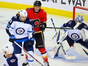 Calgary Flames Milan Lucic battles against Nathan Beaulieu of the Winnipeg Jets during pre-season NHL hockey in Calgary on Tuesday September 24, 2019. Al Charest / Postmedia