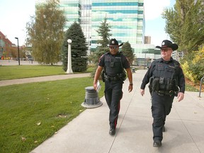 Calgary Police Sgt. Chris Ogwal, left, and Const. Steve Ross patrol the Beltline near the Sheldon M. Chumir Health Centre on Sept. 24, 2019.