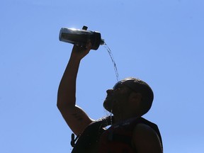 Anthony Blake cools down at Bowness Park before rafting on the Bow River in Calgary on Wednesday, July 29, 2020.