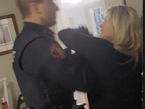 A still frame taken from a video Tara Yaschuk's son recorded of her being arrested by two Calgary Police Service officers.
