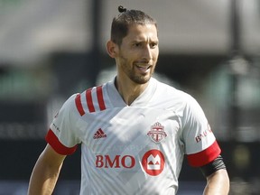 Omar Gonzalez of Toronto FC runs with the ball during a Group C match against the New England Revolution as part of the MLS Is Back Tournament at ESPN Wide World of Sports Complex on the morning of July 21, 2020 in Reunion, Fla.