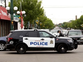 An Edmonton Police Service vehicle makes its way through the 107 Avenue and 101 Street intersection on June 26, 2020. Council has voted to reduce the police service budget by $11 million, the first step in a 20-point police reform plan that is garnering mixed reviews.