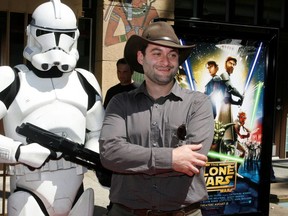 Dave Filoni, director of the new animated film "Star Wars: The Clone Wars", poses with a Storm Trooper character at the film's U.S. premiere in Hollywood, California August 10, 2008.