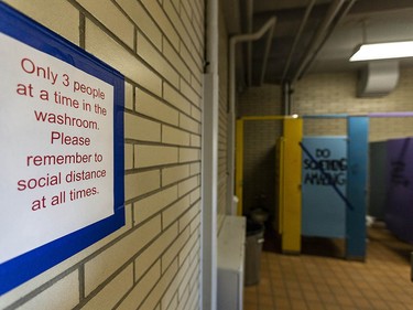 Pictured is a washroom where a number of signs have been put in order to implement physical distancing in Henry Wise Wood High School on Friday, August 28, 2020. Azin Ghaffari/Postmedia