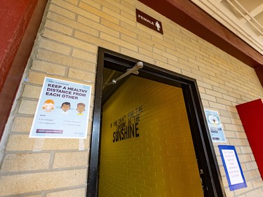 Pictured is the entrance to a washroom where a number of signs have been put in order to implement physical distancing in Henry Wise Wood High School on Friday, August 28, 2020. Azin Ghaffari/Postmedia