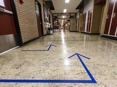 Pictured are arrows showing a one-way traffic corridor to make physical distancing possible in Henry Wise Wood High School on Friday, August 28, 2020. Azin Ghaffari/Postmedia