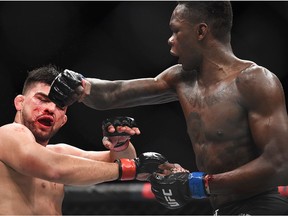 Israel Adesanya of Nigeria punches Kelvin Gastelum during the UFC 236 event at State Farm Arena on April 13, 2019 in Atlanta, Georgia.