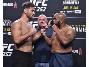 LAS VEGAS, NEVADA - AUGUST 14: In this handout image provided by UFC, (L-R) Opponents Stipe Miocic and Daniel Cormier face off during the UFC 252 weigh-in at UFC APEX on August 14, 2020 in Las Vegas, Nevada.