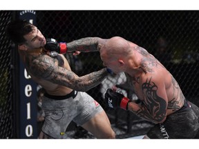 Aleksandar Rakic of Austria and Anthony Smith trade punches in their light heavyweight fight during the UFC Fight Night event at UFC APEX on August 29, 2020 in Las Vegas, Nev.