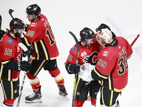 EDMONTON, ALBERTA - AUGUST 01: Andrew Mangiapane #88 of the Calgary Flames celebrates his goal with teammate Cam Talbot #39 of the Calgary Flames against the Winnipeg Jets during the third period in Game One of the Western Conference Qualification Round prior to the 2020 NHL Stanley Cup Playoffs at Rogers Place on August 01, 2020 in Edmonton, Alberta.