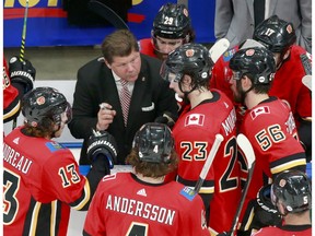 EDMONTON, ALBERTA - AUGUST 03:  Assistant coach Ray Edwards of the Calgary Flames talks with his players as they pull goaltender Cam Talbot in the final minute of the third period against the Winnipeg Jets during Game Two of the Western Conference Qualification Round prior to the 2020 NHL Stanley Cup Playoffs at Rogers Place on August 03, 2020 in Edmonton, Alberta. The Winnipeg Jets defeated the Calgary Flames 3-2.